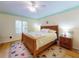 Comfortable bedroom with hardwood floors, natural lighting, and a ceiling fan at 808 E 19Th Ave, New Smyrna Beach, FL 32169