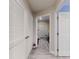 Hallway view showcasing neutral walls and a doorway leading to another room with light gray floors at 808 E 19Th Ave, New Smyrna Beach, FL 32169