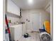 Functional laundry room with white appliances and storage cabinets, combining utility and practicality at 808 E 19Th Ave, New Smyrna Beach, FL 32169