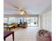 Bright living room with tile flooring, ceiling fan, and sliding glass doors to the patio at 808 E 19Th Ave, New Smyrna Beach, FL 32169