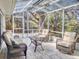 Enjoy this screened patio featuring plenty of seating, decor, and a translucent roof for lots of sunshine at 808 E 19Th Ave, New Smyrna Beach, FL 32169