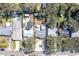 Aerial view showing property, neighborhood, mature trees, and street access at 817 E 12Th Ave, New Smyrna Beach, FL 32169