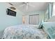 Comfortable bedroom with a queen-sized bed, soft blue tones, and an adjacent bathroom at 817 E 12Th Ave, New Smyrna Beach, FL 32169