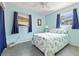 Cozy bedroom featuring bright, airy decor, tile flooring, and natural light from two windows at 817 E 12Th Ave, New Smyrna Beach, FL 32169