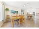 Bright and airy dining room featuring a wooden table, ceiling fan, and stylish decor at 817 E 12Th Ave, New Smyrna Beach, FL 32169