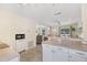 Open kitchen area with a breakfast bar and appliances seamlessly flowing into the dining and living spaces at 817 E 12Th Ave, New Smyrna Beach, FL 32169