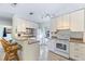 Bright kitchen with white cabinetry, modern appliances, and a convenient breakfast bar with seating at 817 E 12Th Ave, New Smyrna Beach, FL 32169