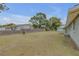 Spacious backyard with a wooden fence and unkept grass at 904 Wilkins St, New Smyrna Beach, FL 32168