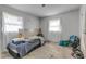 Small bedroom with blue comforter, wood accent wall, and ample natural light at 904 Wilkins St, New Smyrna Beach, FL 32168