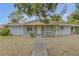 Ranch-style home with carport and mature landscaping at 904 Wilkins St, New Smyrna Beach, FL 32168