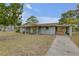 One-story home with a covered porch and driveway at 904 Wilkins St, New Smyrna Beach, FL 32168