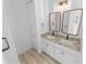 Double vanity bathroom with granite countertops and modern mirrors at 91 Maura Ter, Ponce Inlet, FL 32127