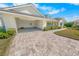 Attached garage with paver driveway at 91 Maura Ter, Ponce Inlet, FL 32127