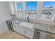 Modern kitchen with a farmhouse sink, granite countertops and ocean views at 91 Maura Ter, Ponce Inlet, FL 32127