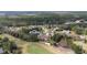 Panoramic view of a home on the golf course showing a meticulously maintained lawn, and mature landscaping at 958 Beach Fern Ct, New Smyrna Beach, FL 32168