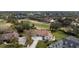 Stunning aerial view of a home with a tile roof and a well-manicured lawn, backing onto a golf course at 958 Beach Fern Ct, New Smyrna Beach, FL 32168