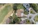 High angle view of a home with a tile roof, next to a golf course and surrounded by lush landscaping at 958 Beach Fern Ct, New Smyrna Beach, FL 32168