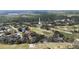 Scenic aerial shot of a charming home next to the golf course and community's mature trees at 958 Beach Fern Ct, New Smyrna Beach, FL 32168