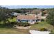 Aerial shot of the rear of the home, showcasing the patio, manicured yard, and beautiful surroundings at 958 Beach Fern Ct, New Smyrna Beach, FL 32168