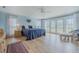 Spacious bedroom with hardwood floors, French doors leading to the backyard, and soft blue accents at 958 Beach Fern Ct, New Smyrna Beach, FL 32168