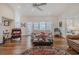 Bright living room featuring hardwood floors, fireplace, and access to the backyard at 958 Beach Fern Ct, New Smyrna Beach, FL 32168