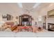 Spacious living room with vaulted ceilings, hardwood floors, and a brick fireplace at 958 Beach Fern Ct, New Smyrna Beach, FL 32168