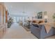 Bright and spacious living room with fireplace, large windows, and comfortable seating arrangement at 958 Beach Fern Ct, New Smyrna Beach, FL 32168