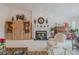 Bright living room featuring a fireplace, piano, built-in shelving and plush armchair at 958 Beach Fern Ct, New Smyrna Beach, FL 32168