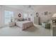 Spacious main bedroom featuring wall-to-wall carpet, ceiling fan, and dual nightstands at 958 Beach Fern Ct, New Smyrna Beach, FL 32168