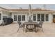 A brick patio features an outdoor dining set, grill, and multiple sets of sliding glass doors at 958 Beach Fern Ct, New Smyrna Beach, FL 32168