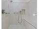 A walk-in shower with a handheld sprayer and shower head offers accessibility at 958 Beach Fern Ct, New Smyrna Beach, FL 32168