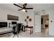 Stylish home office featuring a glass-top desk, comfortable chair, and abundant natural light at 101 Sea St, New Smyrna Beach, FL 32168