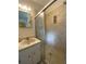 Bathroom featuring a functional vanity sink and a glass enclosed shower at 105 10Th St, New Smyrna Beach, FL 32168