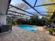 Enclosed pool area with clear blue water, brick surround, and lounge chairs for relaxing poolside at 105 10Th St, New Smyrna Beach, FL 32168