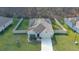 An elevated view showcases a well-maintained single-story home, long driveway, fenced yard, and mature trees at 114 Sunset Point Dr, Ormond Beach, FL 32174