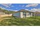The exterior view of a home with a spacious, grassy backyard and privacy fence at 114 Sunset Point Dr, Ormond Beach, FL 32174