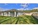 An expansive backyard features a well-maintained lawn, a partial fence line, and mature trees at 114 Sunset Point Dr, Ormond Beach, FL 32174