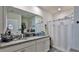 A full bathroom features dual sinks, granite countertops, and a shower with a curtain at 114 Sunset Point Dr, Ormond Beach, FL 32174