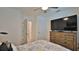 Comfortable bedroom with a ceiling fan, wooden dresser, and access to other areas at 114 Sunset Point Dr, Ormond Beach, FL 32174