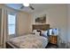A well-lit bedroom featuring a plush bed, a wooden headboard, and modern décor at 114 Sunset Point Dr, Ormond Beach, FL 32174