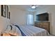 Bedroom with a wooden dresser, large television, and a comfortable-looking bed at 114 Sunset Point Dr, Ormond Beach, FL 32174