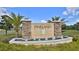 Stone-accented Pineland community entrance sign with a water feature and manicured landscaping at 114 Sunset Point Dr, Ormond Beach, FL 32174