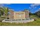 Stone-accented Pineland community entrance sign with a water feature and manicured landscaping at 114 Sunset Point Dr, Ormond Beach, FL 32174