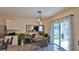 Dining area with modern table set, pendant lighting, and sliding glass doors at 114 Sunset Point Dr, Ormond Beach, FL 32174