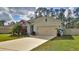 Beautiful single-story home features well-kept lawn, neutral paint, and a spacious driveway leading to a two-car garage at 114 Sunset Point Dr, Ormond Beach, FL 32174