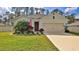 Inviting single-story home features manicured lawn, lush landscaping, and a convenient attached two-car garage at 114 Sunset Point Dr, Ormond Beach, FL 32174