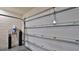 White garage door with water filtration system in foreground in a two car garage at 114 Sunset Point Dr, Ormond Beach, FL 32174