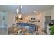 Open concept kitchen with granite countertops, modern appliances, and eat-in island with pendant lights at 114 Sunset Point Dr, Ormond Beach, FL 32174
