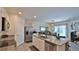 Open kitchen with granite counters, island, stainless steel appliances and view to the dining area at 114 Sunset Point Dr, Ormond Beach, FL 32174