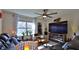 Cozy living room with modern furnishings, a ceiling fan, and a large window at 114 Sunset Point Dr, Ormond Beach, FL 32174